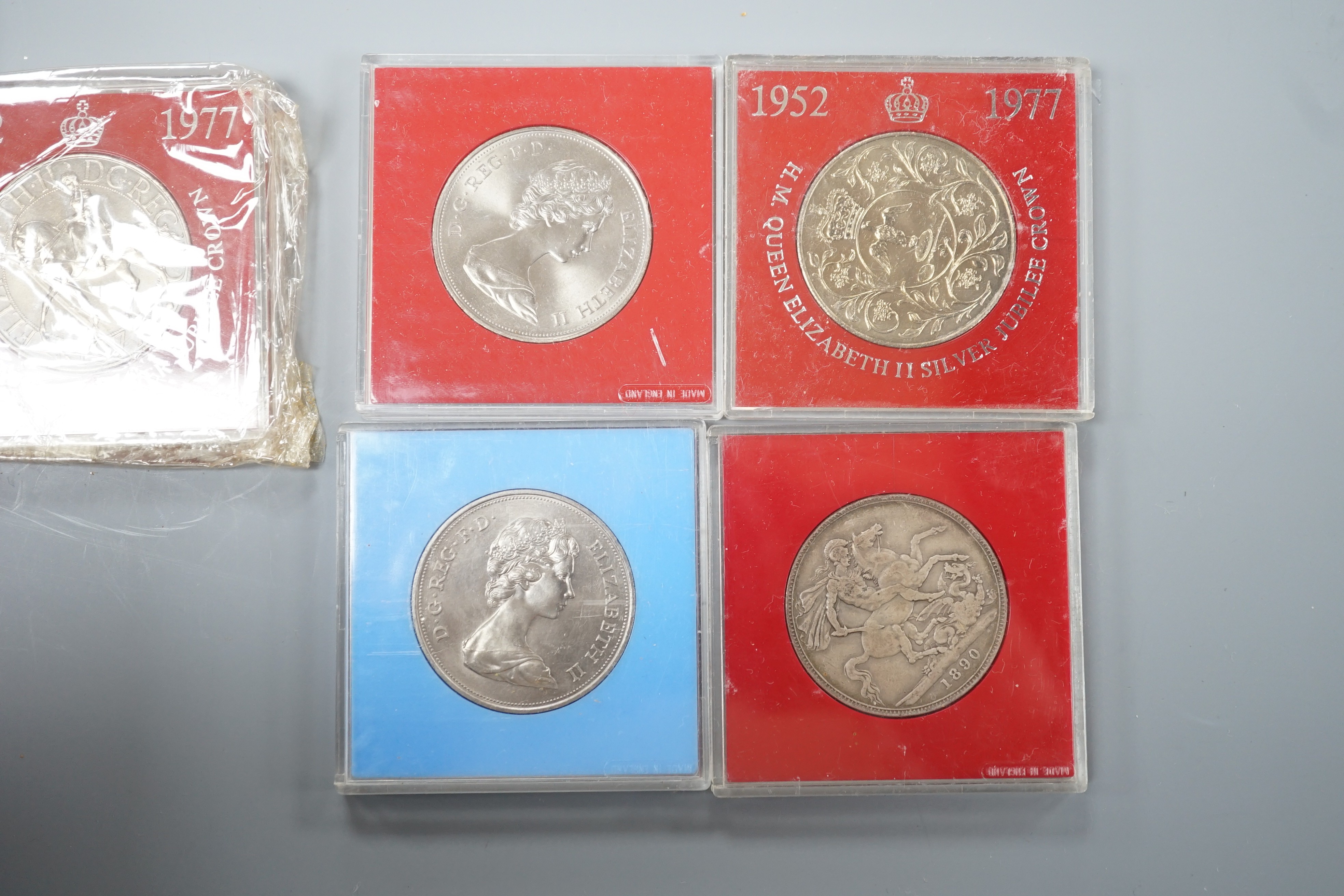 A collection of coins including a Victoria crown and two florins